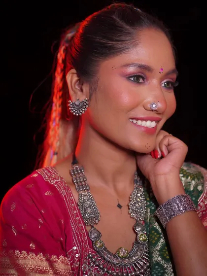 Another angle of the festive look, showcasing the silver jewelry that complements the makeup perfectly.