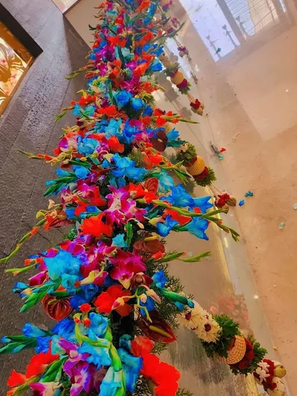 A vibrant and colorful floral decoration for a glass railing. The mix of blue, red, and purple orchids looks stunning.
