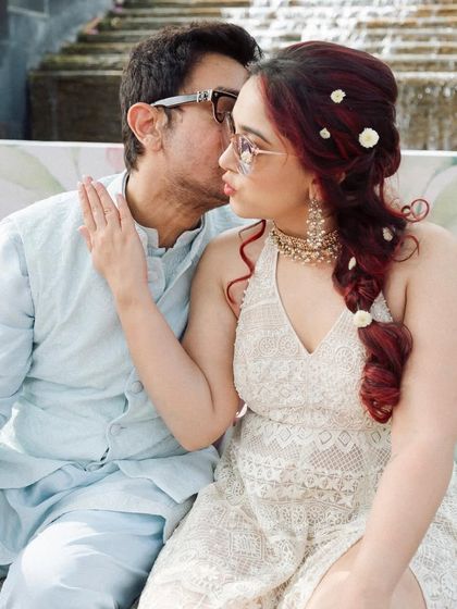 A father whispers something to his daughter, sharing a private joke. These are the priceless, unscripted interactions that make a wedding day so memorable.