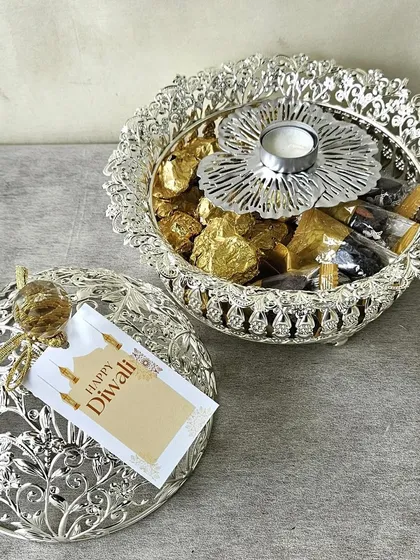 An ornate silver-domed container filled with chocolates and a matching T-light holder. This piece is perfect as a standalone gift or as part of a larger hamper, exuding traditional charm.