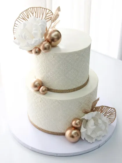 Wedding season is here! I love how this minimalistic and gorgeous wedding cake turned out, featuring a delicate stencil pattern, gold accents, and handmade wafer paper flowers.