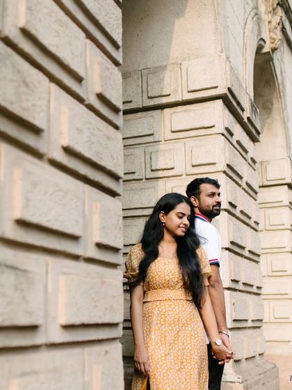 Using the strong, repeating patterns of a stone wall to create a visually interesting and textured background. This pose feels both connected and effortlessly cool for an urban pre-wedding shoot.