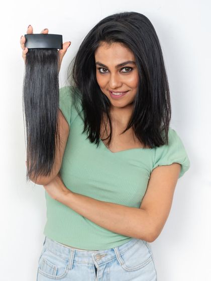 Our side bangs and Velcro clutch extensions are fully customizable. This model holds a side bang piece, showing how it can be tailored to blend seamlessly with your hair for a style boost.