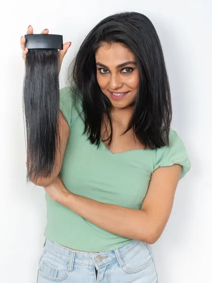 Our side bangs and Velcro clutch extensions are fully customizable. This model holds a side bang piece, showing how it can be tailored to blend seamlessly with your hair for a style boost.