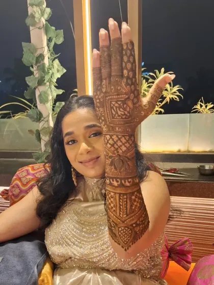 One hand up to show the world. This close-up highlights the fine lines and detailed figures that make my bridal mehndi special.