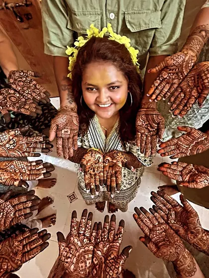 Mehendi is a celebration shared with loved ones. Here is a happy bride surrounded by her family and friends, all showing off their henna. My team and I can comfortably cater to your entire bridal party.