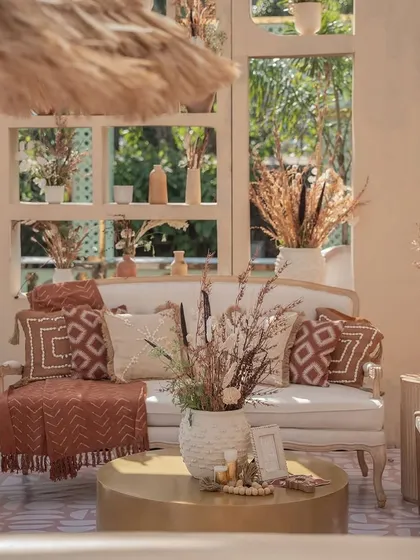 A close-up of the cozy seating area from the 'Desert Oasis' Haldi. I selected pillows and throws with geometric, earthy-toned patterns to perfectly match the rustic and elegant theme.