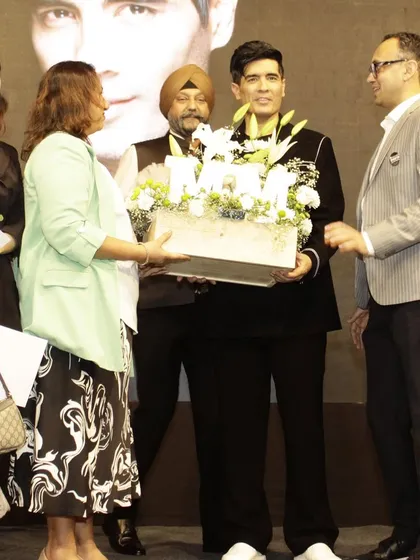 Another shot of me presenting the white floral hamper to Manish Malhotra, a moment of pride and joy.