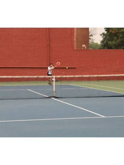 A junior player practicing against the wall, a classic drill to improve consistency and footwork. Foundational skills are a core part of our junior development program.