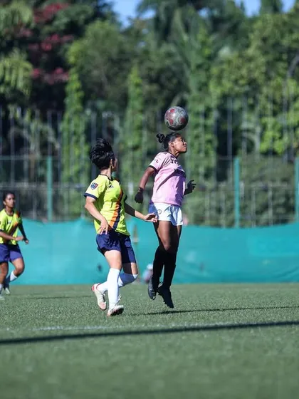 A player leaping for a powerful header during a competitive match. Our aerial game is as strong as our ground game.