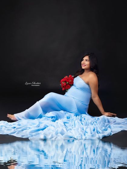 A dreamy, artistic portrait with a water reflection effect, making this light blue gown look even more ethereal.