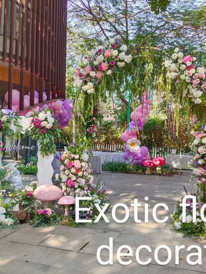 Another view of the enchanting birthday party entrance. The floral arch is complemented by pink and purple balloons, creating a perfect welcome for a magical celebration.
