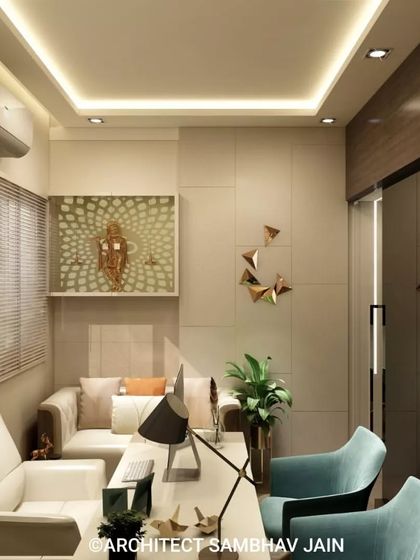A sophisticated cabin space featuring a minimalist layout with plush ivory seating, aqua-toned accent chairs, and a sleek white desk. The space is adorned with gold geometric art and a radiant Krishna motif, exuding modern sophistication.