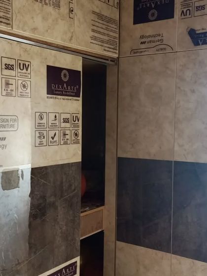 A sliding wardrobe with protective film, part of a project 100 kms from Bengaluru. We deliver and install our factory-finished modular furniture across South India.