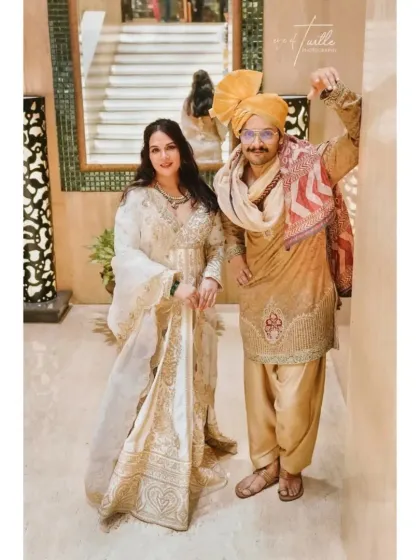 A fun and playful portrait of the couple. The groom's cheerful pose and the bride's elegant smile show the fun side of their relationship.