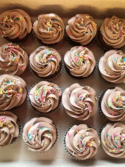 A close-up of the chocolate cupcakes, showing the fluffy frosting and colorful sprinkles. They are a guaranteed hit at any birthday celebration.