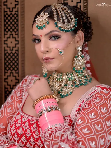 A tight close-up focusing on the bride's expressive eyes and the beautiful details of her maang tikka and nath.