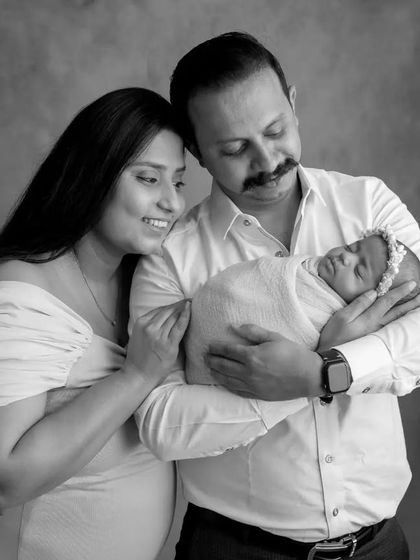 A beautiful black and white family portrait, capturing a classic pose that will be cherished for years.