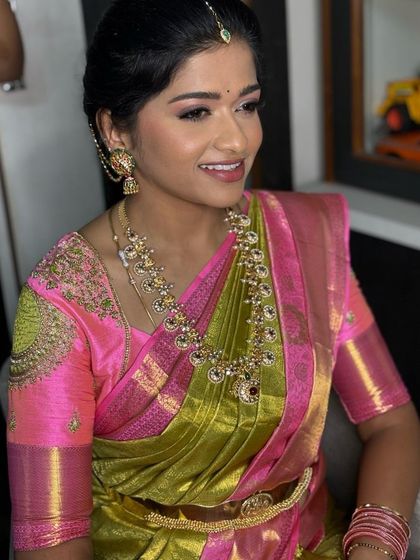 Our client Rishika in a designer silk saree with a breathtaking combination of pink and green.