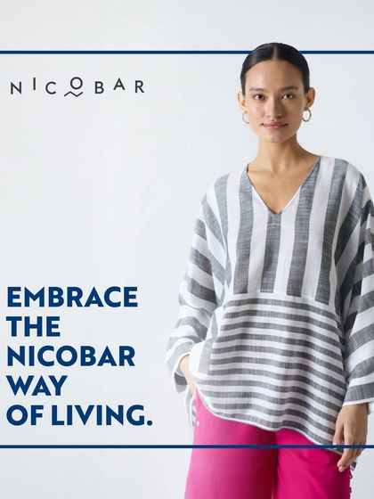 A model in a simple, elegant striped top from Nicobar. This image embodies the brand's philosophy of embracing a mindful, uncluttered way of living.