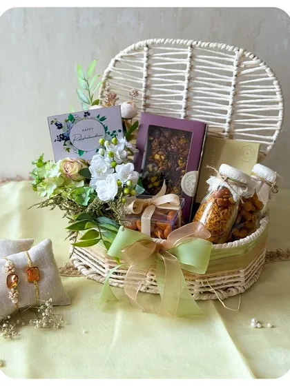 A lovely wicker basket hamper for Rakhi, filled with our granola, chocolate barks, and fresh flowers.