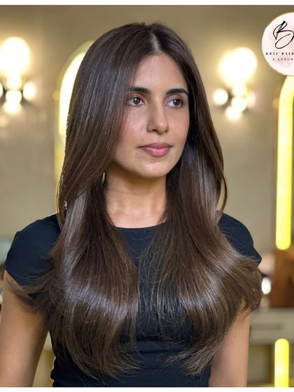 Another angle of the ashy brunette look, showing how the color looks under different lighting. The cool undertones are consistent and the hair has a healthy, natural sheen.