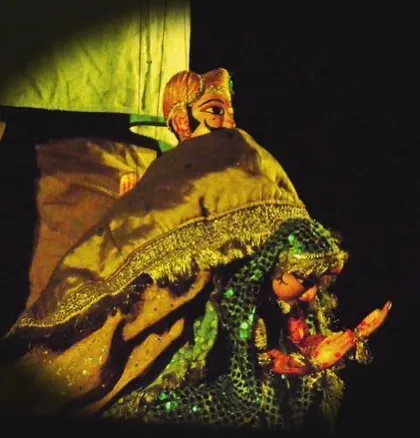 A romantic scene from a puppet show, showing a king and queen. These moments are created with delicate movements of the strings.