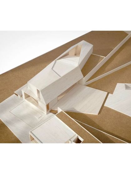 A detail of the Lakehouse model, highlighting the interlocking volumes and the way the building straddles the line between the enclosed forecourt and the open lakeside.