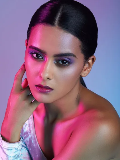 A vibrant look from our Bangalore academy, featuring a purple smokey eye and dramatic pink and blue lighting.