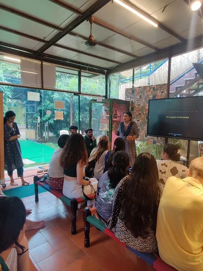 I am giving a presentation to a group of visiting university students as part of their cultural immersion program. Sharing the history and philosophy behind Indian puppetry is a key part of our mission to educate and inspire.