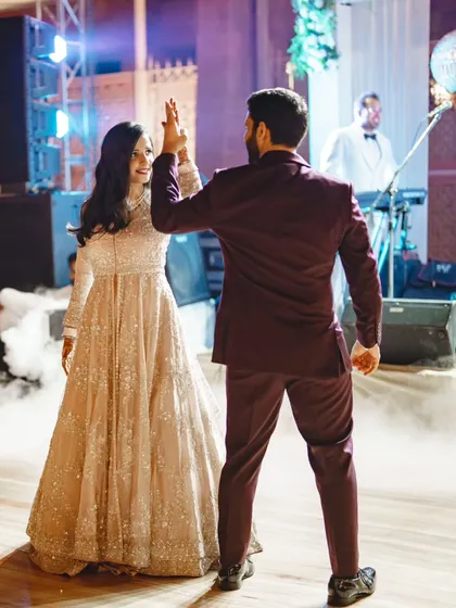 A sweet high five between the couple during their performance. It's these small, genuine moments of connection that make a sangeet dance so special.