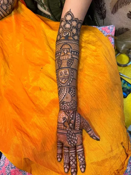 A full arm view of a traditional bridal design. We've included kalash motifs, peacocks, and floral patterns, all tied together with intricate borders.