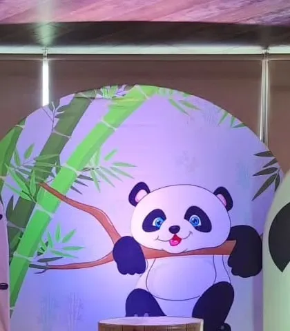 A cute panda-themed backdrop, part of a larger party setup.