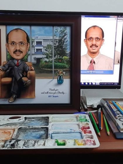 Here is the final framed caricature for the boss, shown next to the original photo, ready to be gifted. Our workspace shows the tools we use for our handmade art.