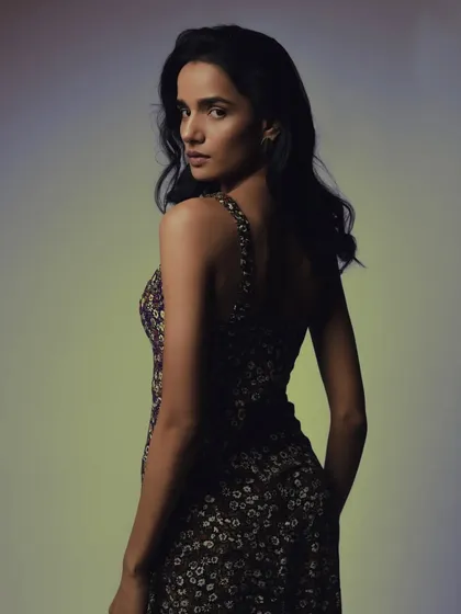 A beautiful shot looking over the shoulder. The lighting creates a soft glow on her skin, enhanced by the minimal makeup application.