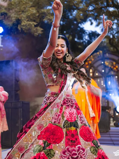 The bride enjoying her moment on the dance floor, with spotlights adding to the drama and energy of her performance.