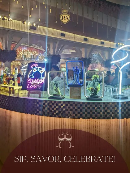 Sip, savor, and celebrate with us. This photo captures the lively ambiance of an event we catered, complete with a stylish bar and neon signs, creating an unforgettable atmosphere.