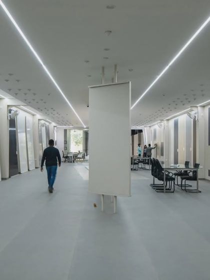 More images from the Krsimar marble showroom, detailing the sliding panel display system and the clean, spacious layout designed for an optimal client experience.