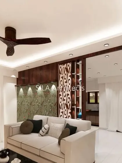 Our signature interior design for a client in JP Nagar, Bengaluru. This living room features a vertical garden wall, intricate jali partitions, and a calm, neutral sofa, creating a blend of nature and elegance.