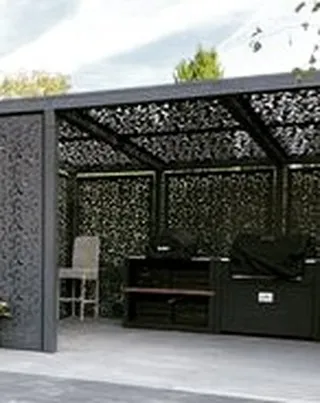 A custom-designed pergola with laser-cut decorative panels for the roof and walls. This unique structure provides dappled shade and creates intricate light patterns, serving as a functional art piece.