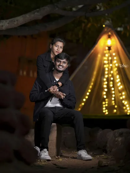 A romantic shot in front of a lit-up tent. This camping-themed setup is perfect for adventurous couples.