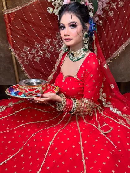 This red georgette lehenga with gold buttis is lightweight yet festive. It's shown here styled for Karwa Chauth, complete with a puja thali, showcasing its versatility.