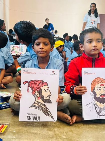Young students proudly display their colored portraits of heroes like Sangolli Rayanna and Chhatrapati Shivaji. Choosing our heroes wisely shapes who we become.