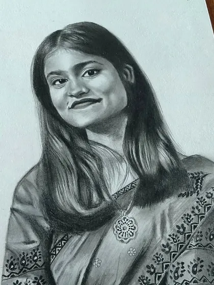 A portrait of a woman in a saree, showing the detailed patterns of her clothing.