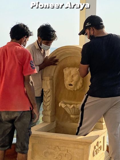 Our skilled team carefully positions the heavy stone water feature on the terrace. This hands-on process ensures every element is installed perfectly, bringing our detailed design plans to life.