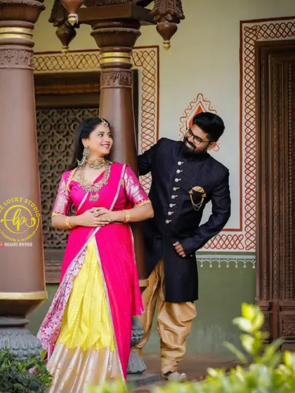 I provide coordinated ethnic wear for couples who want a traditional touch in their photoshoots. This set features a vibrant pink and yellow lehenga paired with a classic navy blue sherwani.