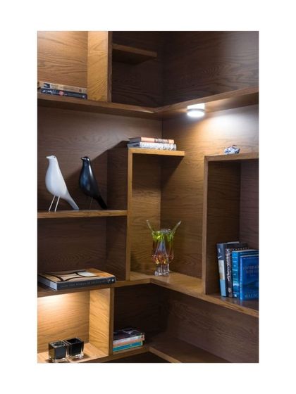 This abstract shelving unit from our Sattva House project is crafted from sustainable plantation timber. The adjustable shelves cater to items of different sizes, making it a versatile and artistic storage option.