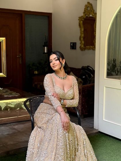 A full portrait of a client ready for her event. The hairstyle is a half updo with voluminous waves, keeping the hair away from her face while showcasing its length.