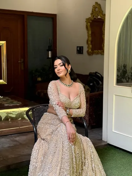 A full portrait of a client ready for her event. The hairstyle is a half updo with voluminous waves, keeping the hair away from her face while showcasing its length.