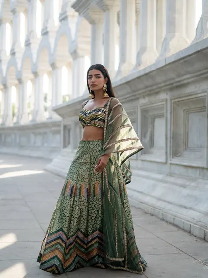 Creating picture-perfect moments and memories. This beautiful green lehenga with a multi-patterned design is available to rent now.